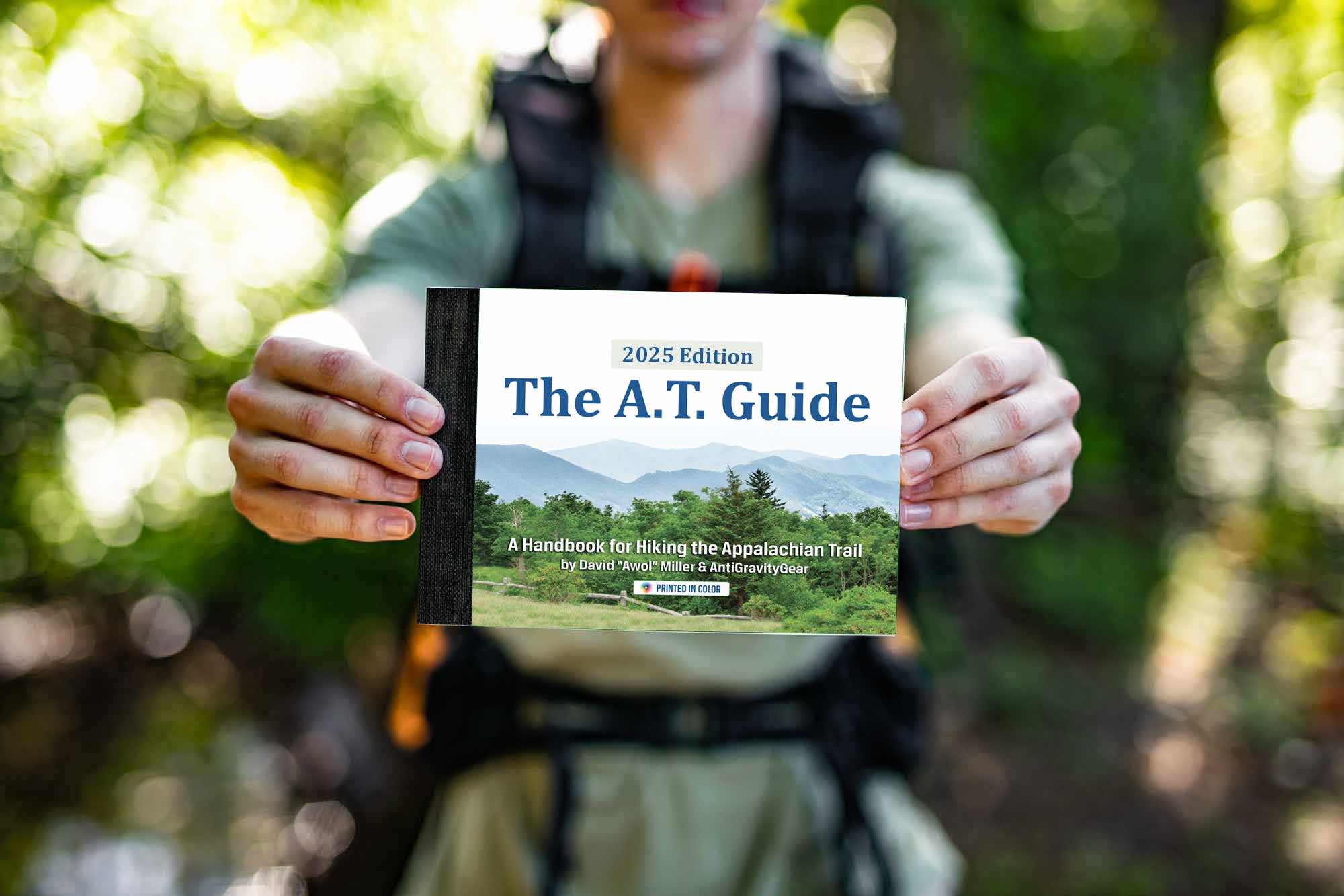 Hiker holding 2025 Edition of The AT Guide